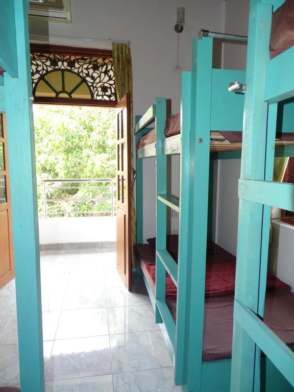 Postel nebo postele na pokoji v ubytování Ceylon Glory Hostel