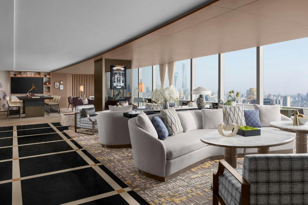 a living room with couches and tables in a building at Shanghai Marriott Marquis City Centre in Shanghai