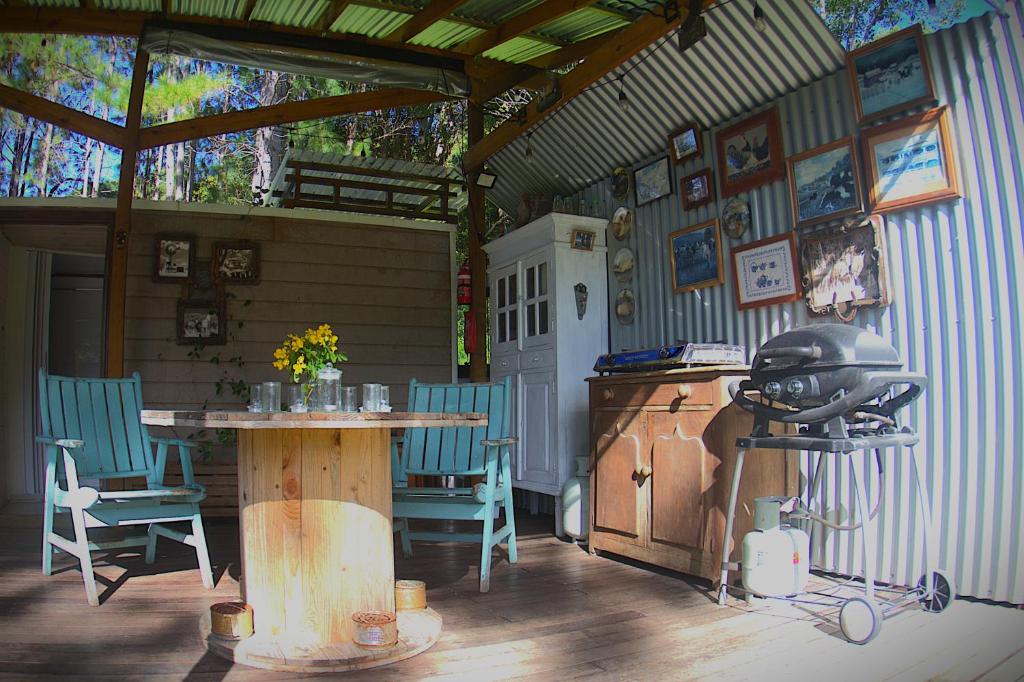 a patio with a table and chairs and a stove at Paddock Shack in Carool