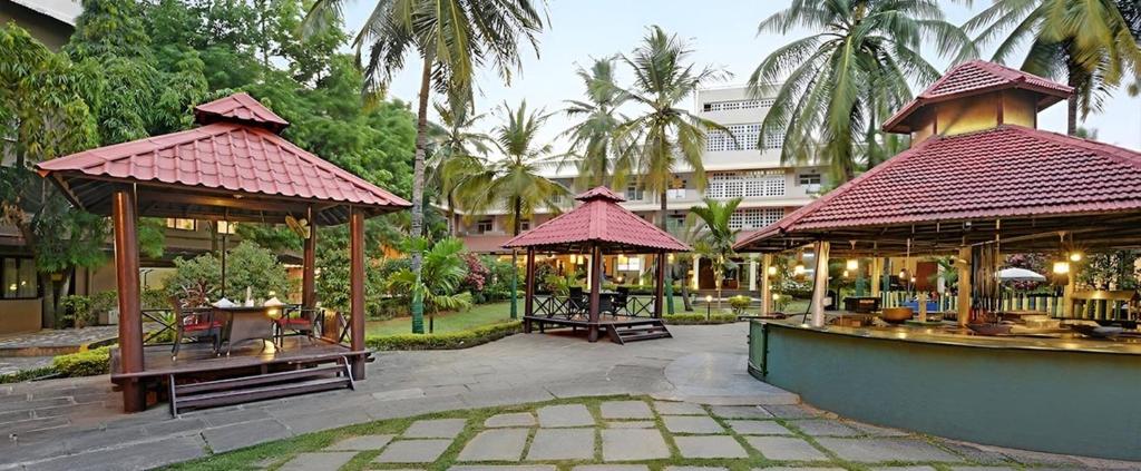 a resort with two gazebos in a courtyard at Royal Orchid Resort & Convention Centre, Yelahanka Bangalore in Bengaluru