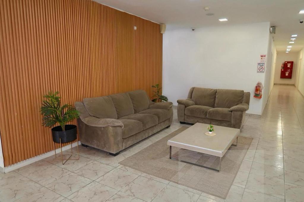 a lobby with two couches and a coffee table at Bella Vista House in Eilat