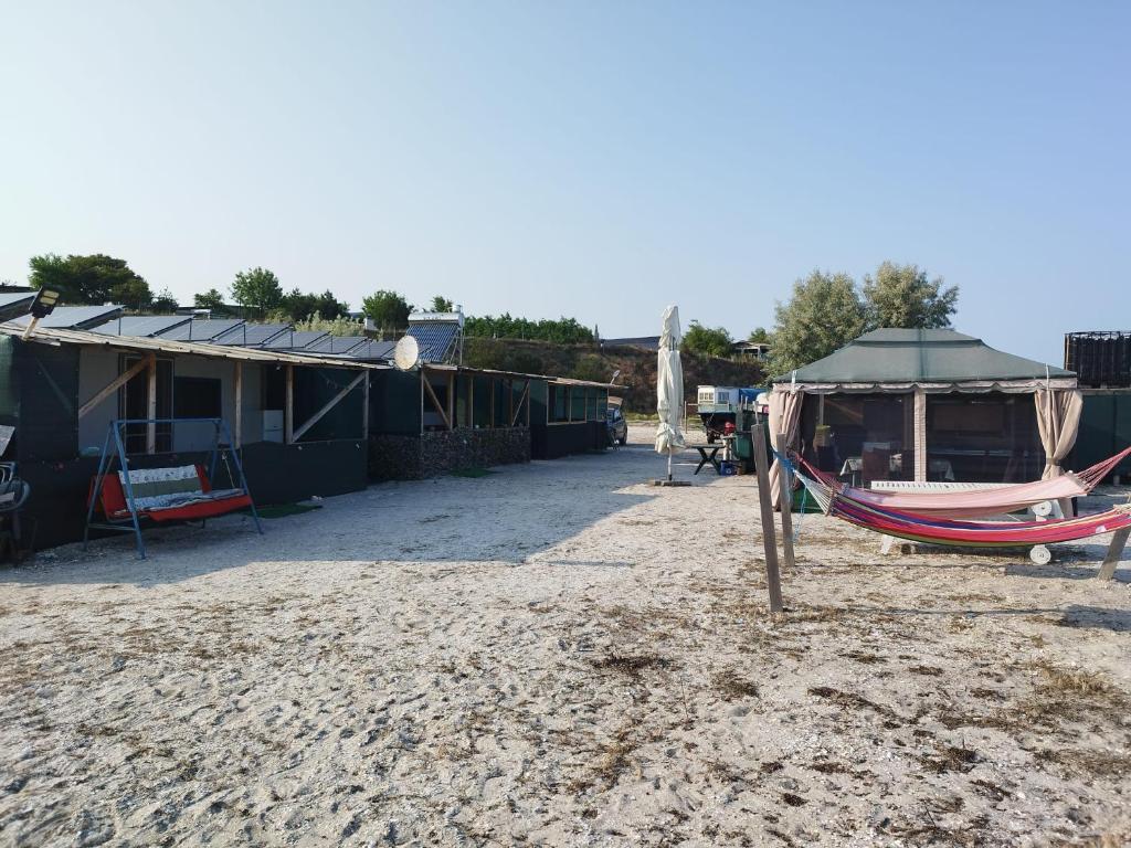 a hammock and a tent on the beach at Camping malul marii Corbu in Corbu