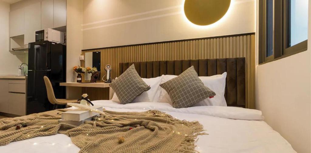 a bedroom with a bed with a blanket on it at Lucentia Residences BBCC LaLaport in Kuala Lumpur