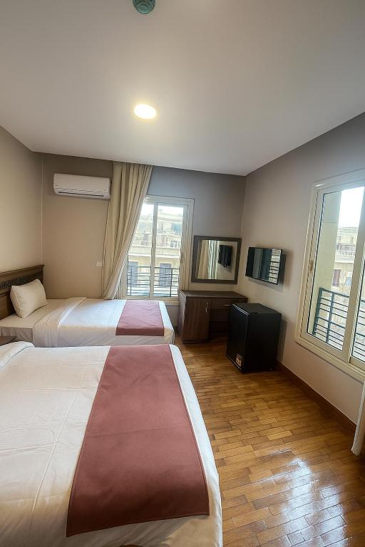 Postel nebo postele na pokoji v ubytování New Lotus Hotel