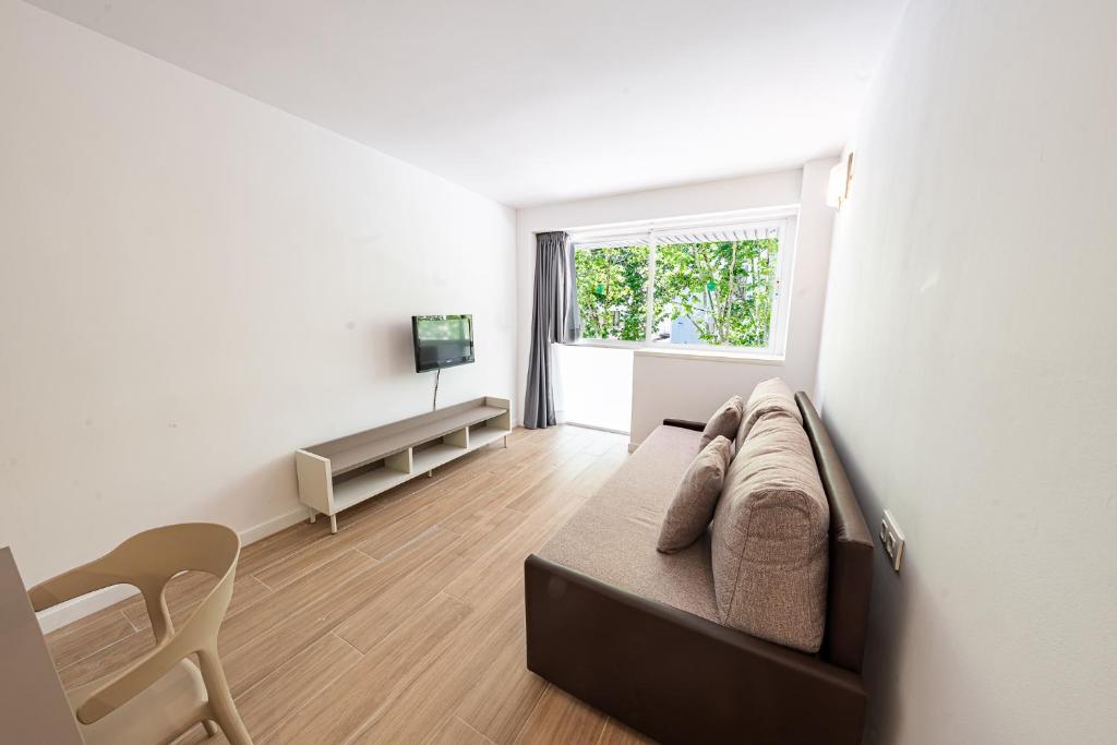 Televízia a/alebo spoločenská miestnosť v ubytovaní Park Suites Family Rentalmar