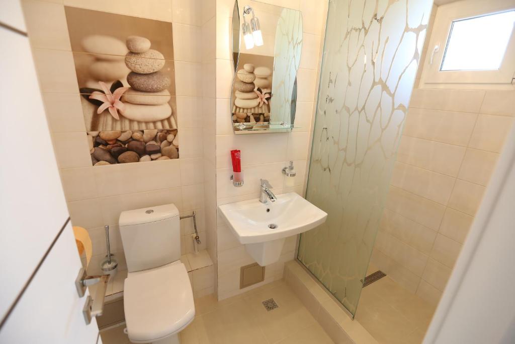 a bathroom with a toilet and a sink at Panorama Suite in Galaţi