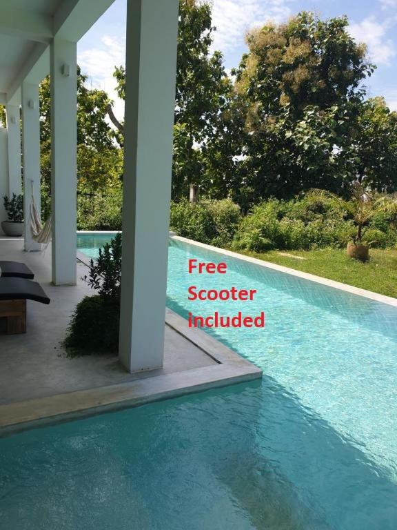 a free seafood included sign next to a swimming pool at Giri Villa in Tangalle