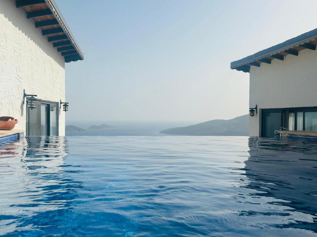 a swimming pool with a view of the water at Patika Villas in Kalkan
