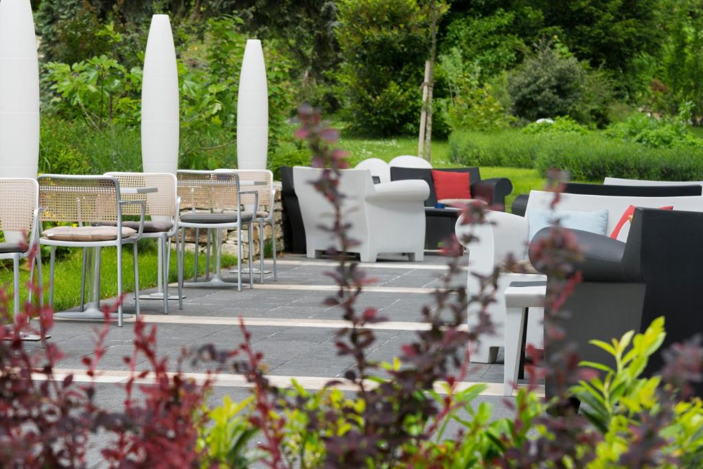 a row of chairs and tables in a garden at At the Park Hotel in Baden