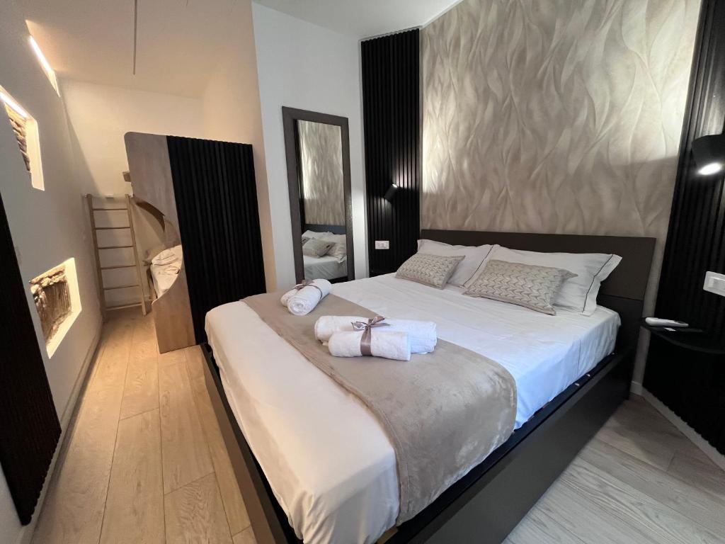 a bedroom with a large bed with towels on it at Como Charm Living Apartment Duomo in Como