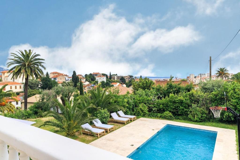 a view of a swimming pool from a balcony at Large villa near beach, sea view, islands & bay of Cannes, 7 bedrooms in Cannes