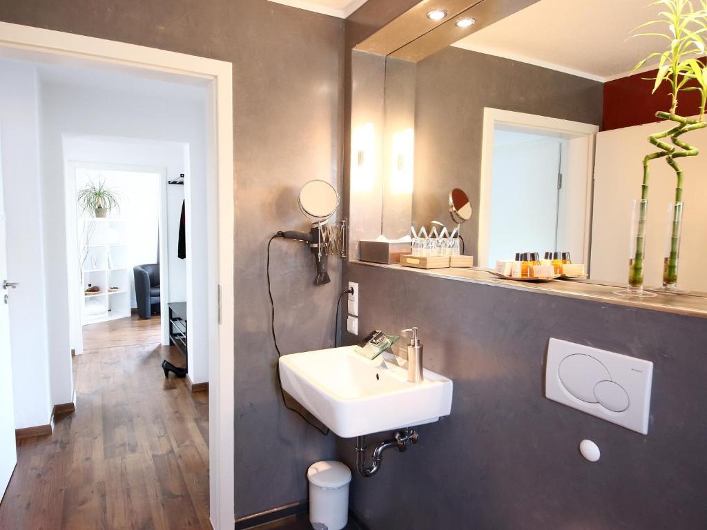 a bathroom with a sink and a mirror at TS Apartments in Traunstein