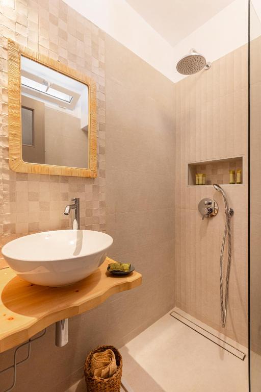 a bathroom with a sink and a shower at Nisea Hotel Samos in Pythagoreio