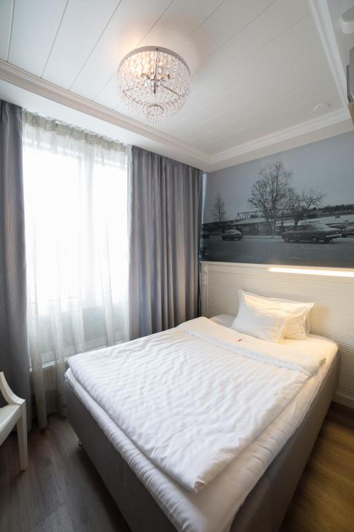 Postel nebo postele na pokoji v ubytování Hotelli Olof