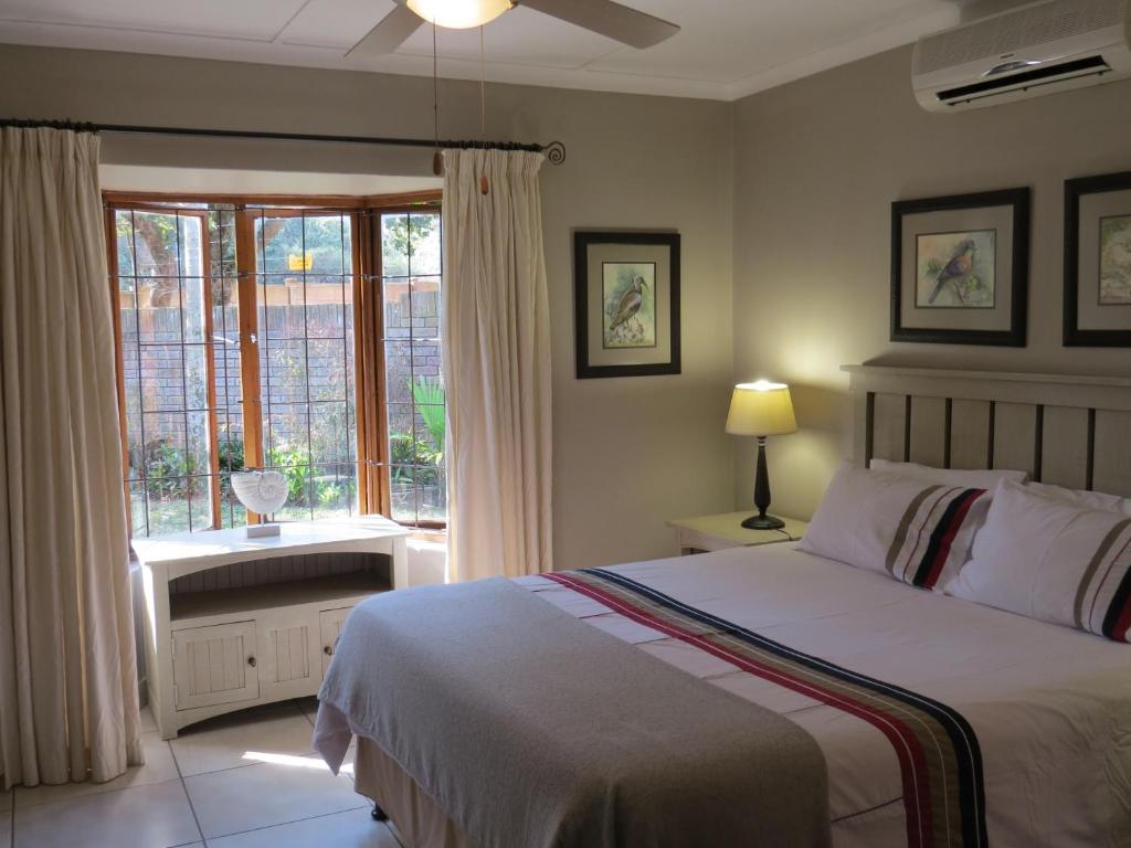 a bedroom with a large bed and a window at La Dolce Vita Cottage in St Lucia