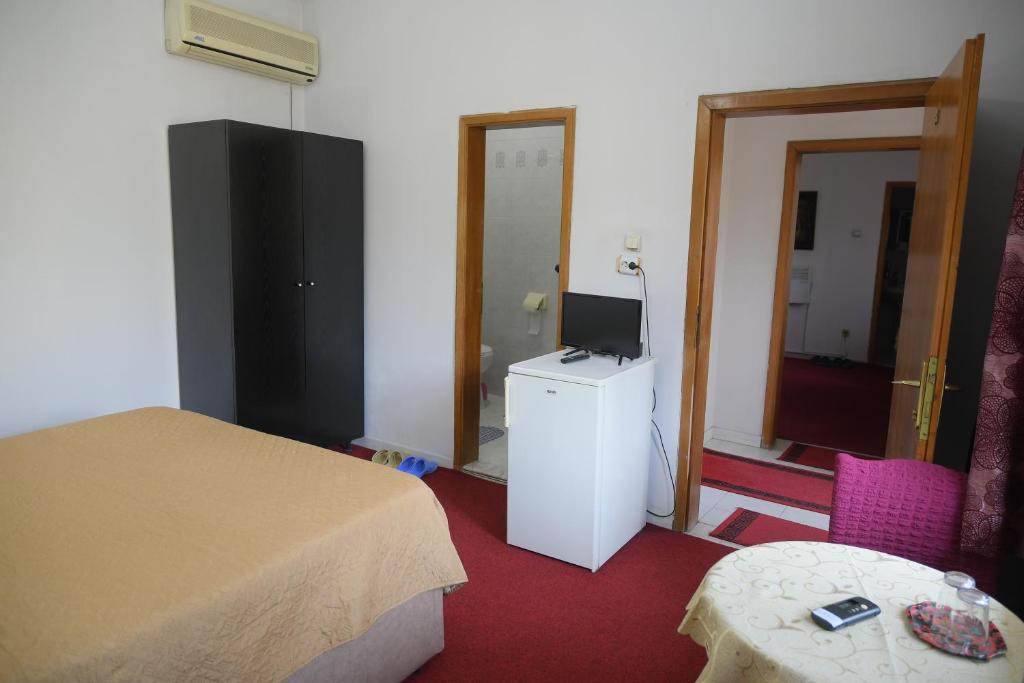 Postel nebo postele na pokoji v ubytování Hotel HAXHIU