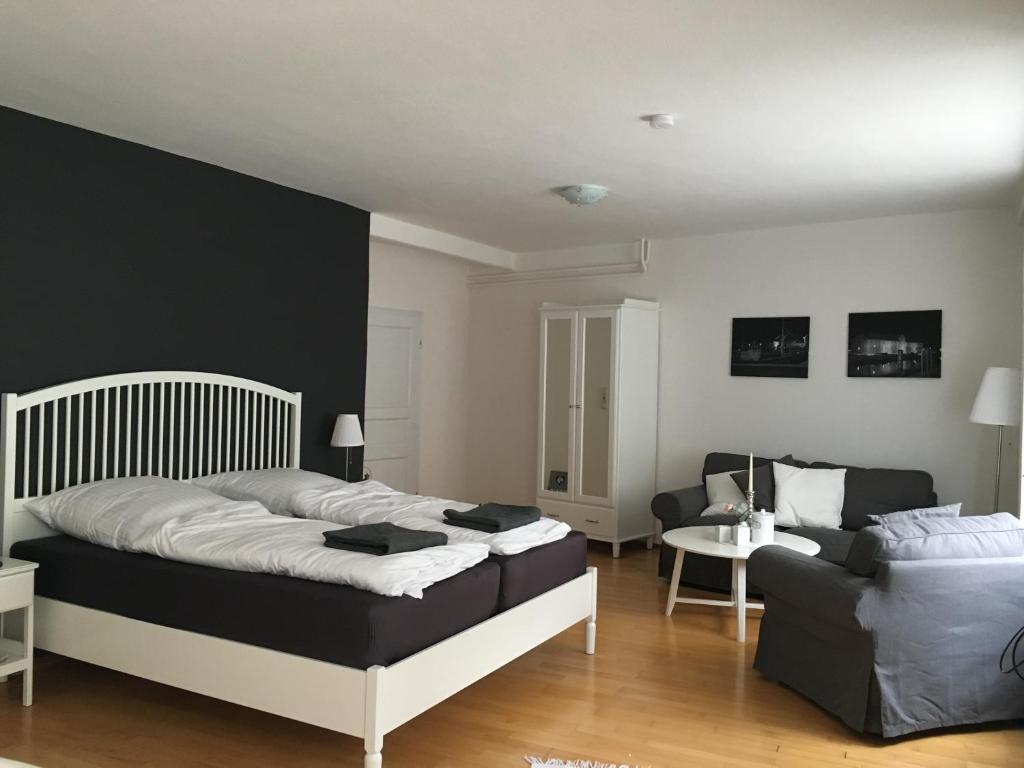 1 dormitorio con 1 cama y 1 sofá en Gasthaus Hafenblick, en Tönning