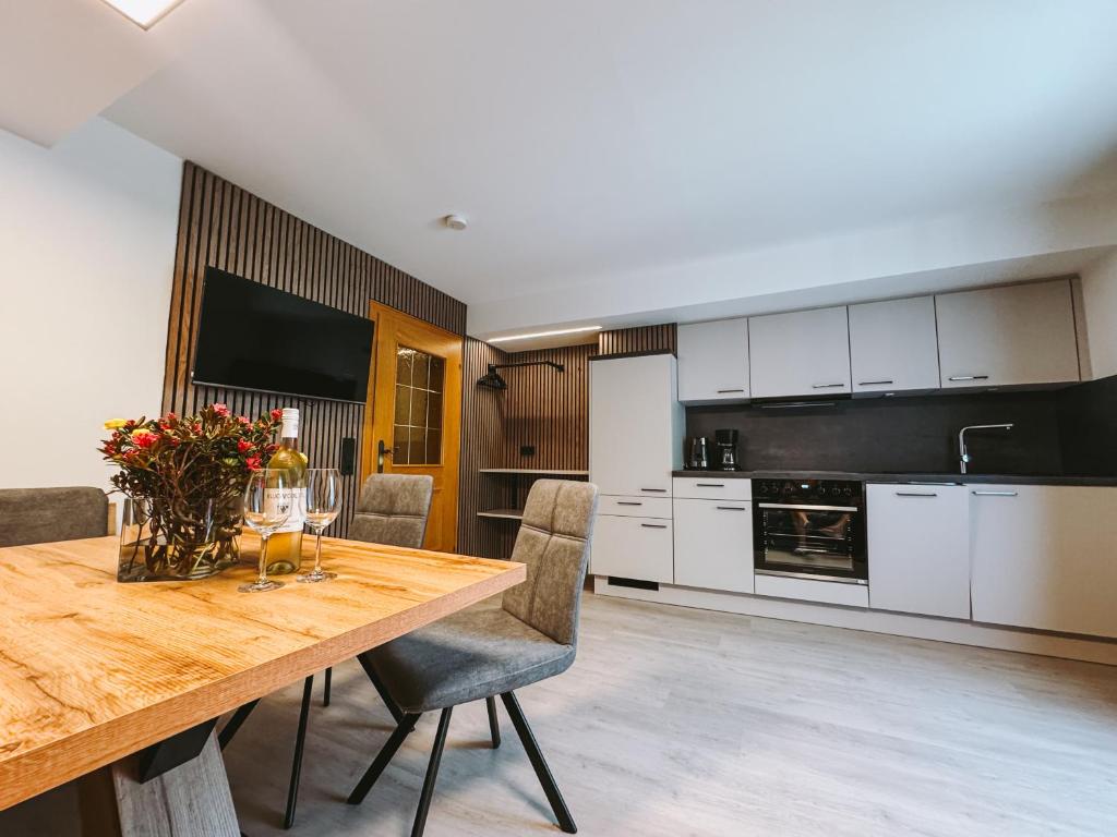 a large kitchen with a wooden table and chairs at Ferienhaus Antonia in Dorfgastein