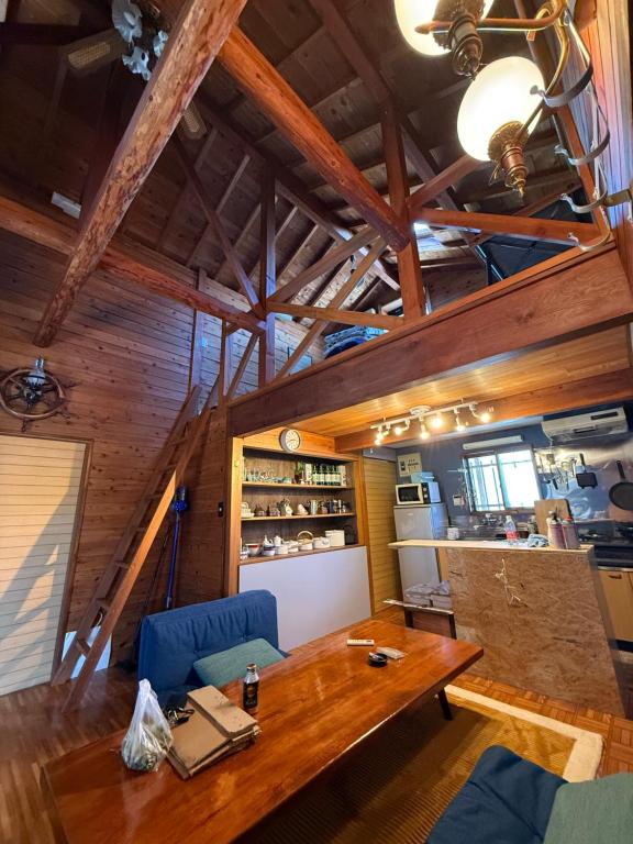 a dining room with a wooden table and blue chairs at Hakushu hutte in Hokuto