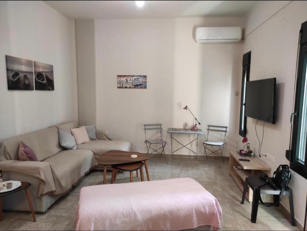 a living room with a couch and a tv at Kavala Summer in Kavála
