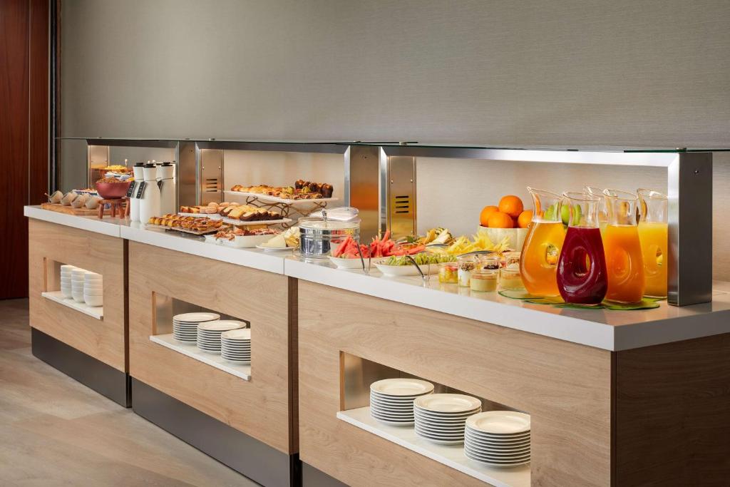 a buffet line with a lot of food and drinks at NH Sintra Centro in Sintra
