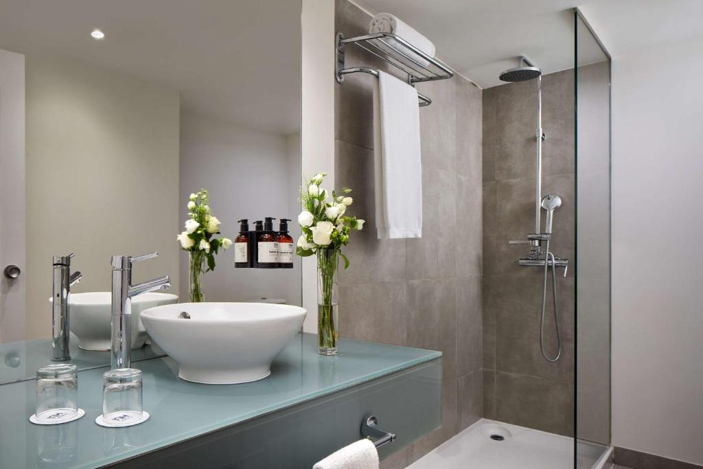 a bathroom with a sink and a shower at NH Sintra Centro in Sintra