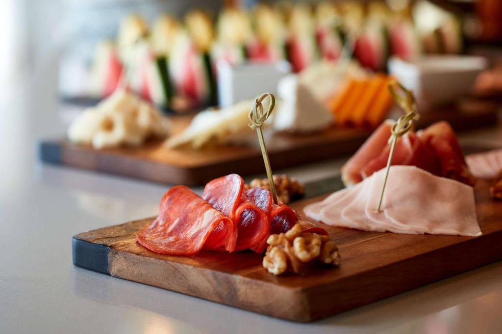 a bunch of different types of meats on a cutting board at NH Sintra Centro in Sintra