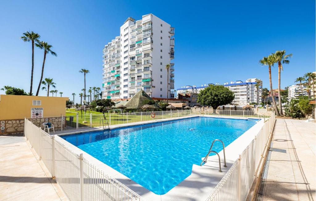 a swimming pool with a building in the background at Beautiful Apartment In Benalmadena in Benalmádena
