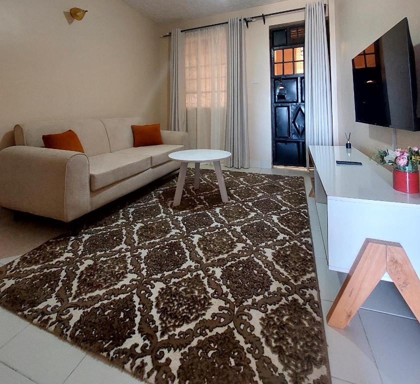 a living room with a couch and a table at Staycation with Karimi in Embu