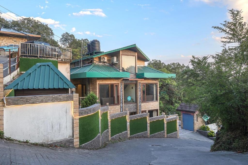 a house with a fence in front of it at SaffronStays Barlowganj Villa in Mussoorie