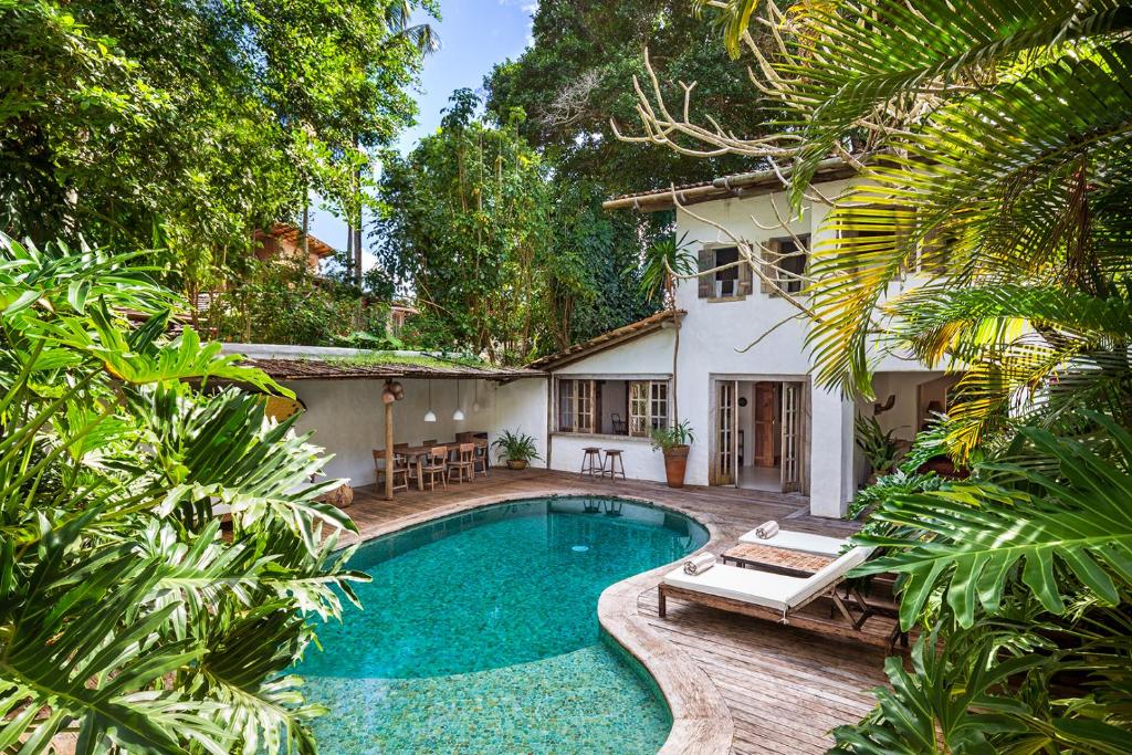 a swimming pool in front of a house at Vila Santo Rei Trancoso in Trancoso