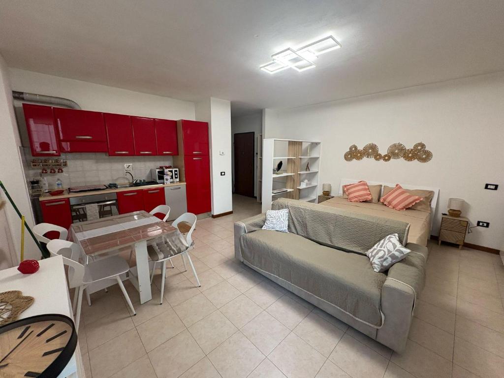 een slaapkamer met een bed en een keuken met rode kasten bij La Ciminiera in Prato