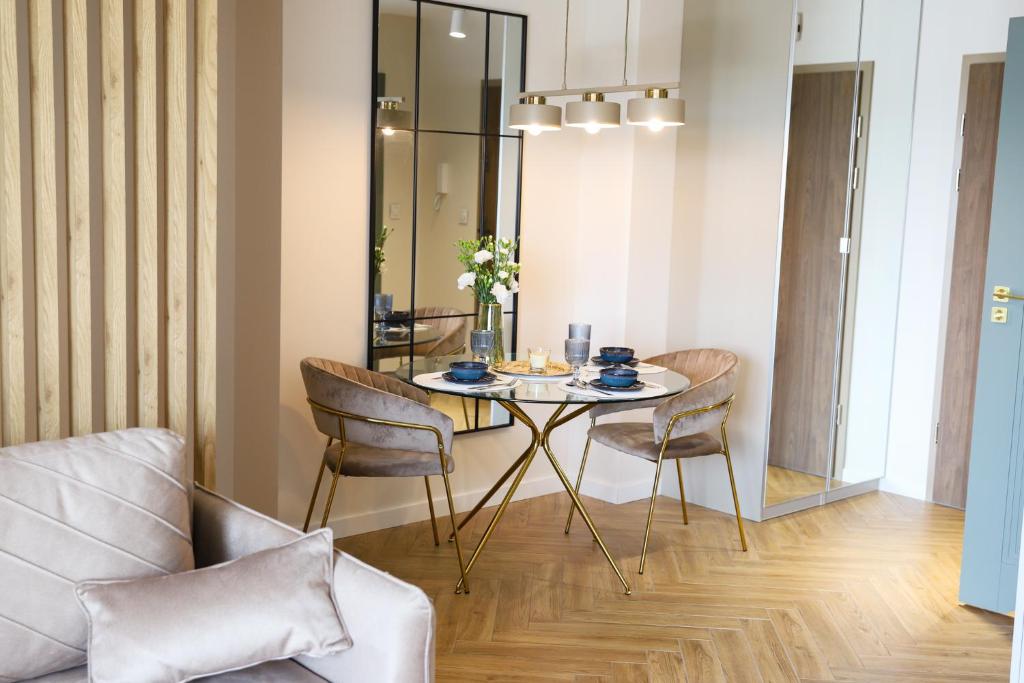 a dining room with a table and chairs at Apartament Valentino Bussines Haven & Family in Kielce