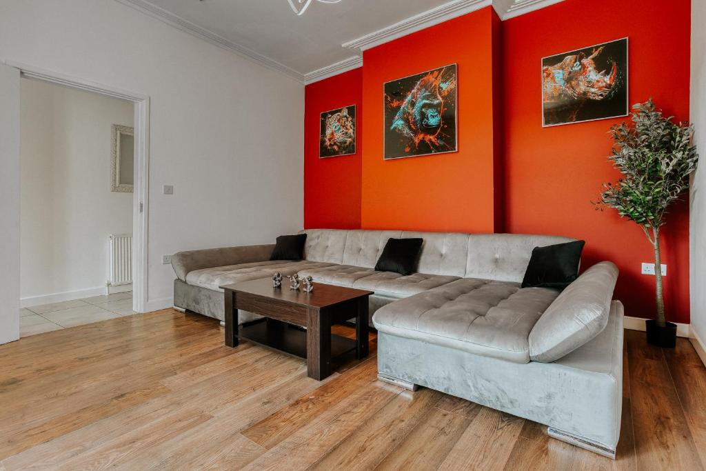 a living room with a couch and a table at Open Mind Property - 4 Bedroom House with Hot Tub in Weston-super-Mare