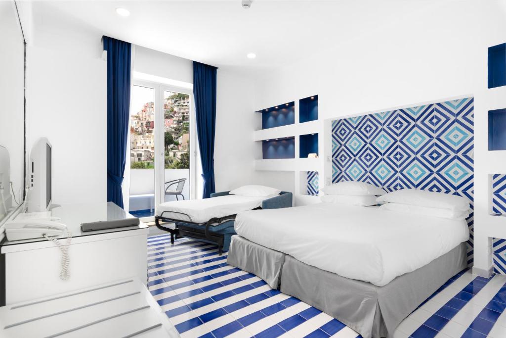 Postel nebo postele na pokoji v ubytování Hotel Bougainville
