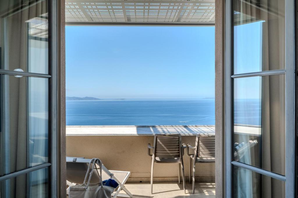 a view of the ocean from the balcony of a condo at Hôtel La Villa Douce in Rayol-Canadel-sur-Mer