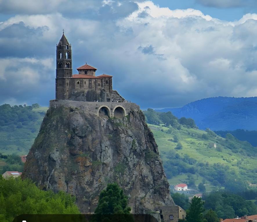 a castle on the top of a mountain at La Vallée De La Loire in Solignac-sur-Loire