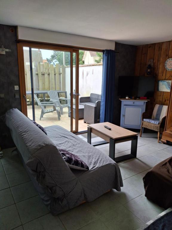 une chambre avec un lit et un salon dans l'établissement maison en bord de mer, à L'Aiguillon-la-Presqu'île