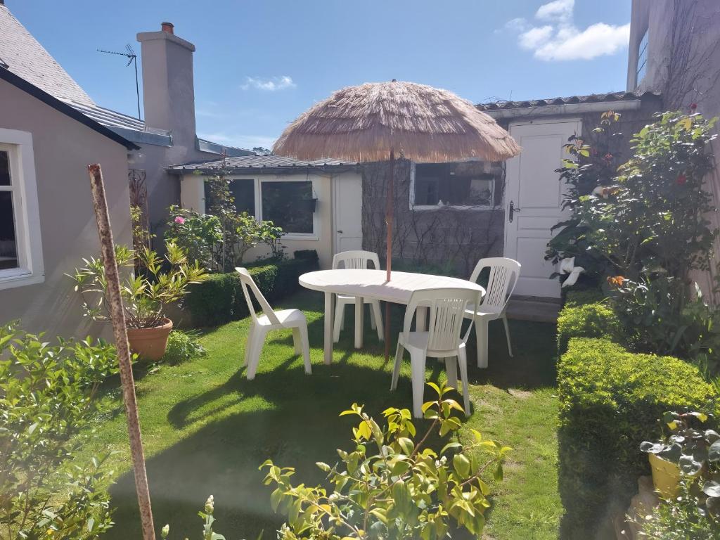 d'une terrasse avec une table et des chaises dans la cour. dans l'établissement Morgat plage Appart 1er coté rue, à Crozon