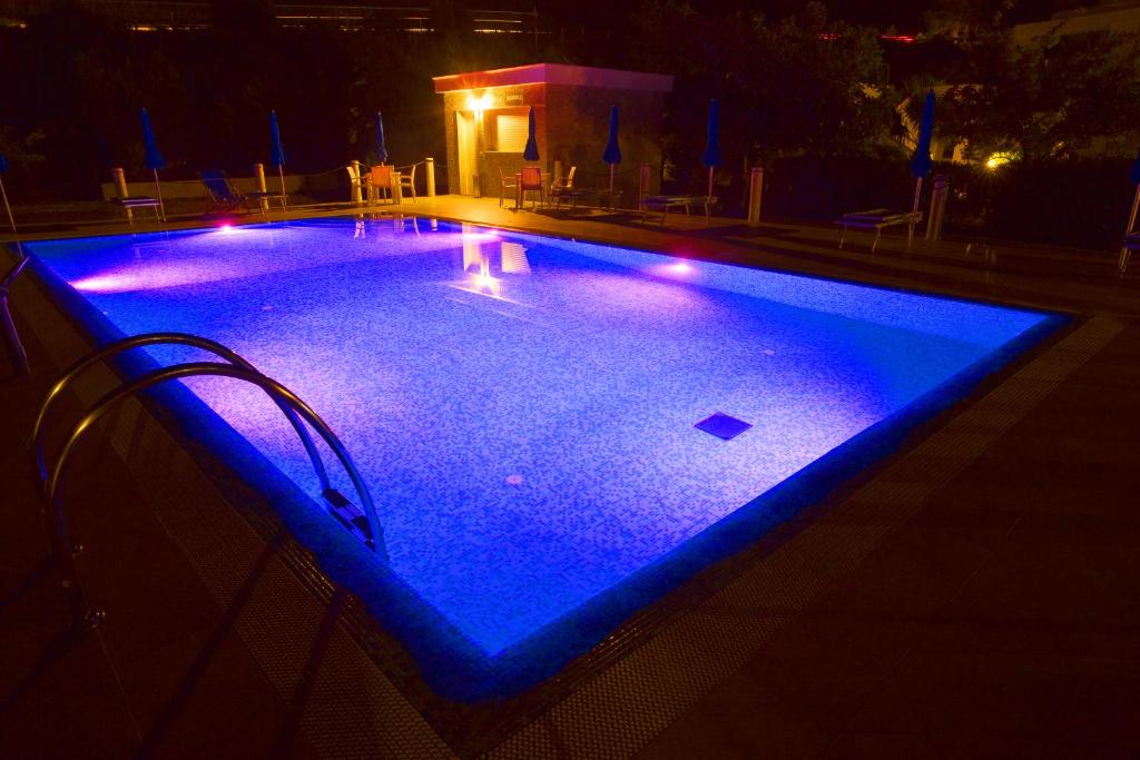 a swimming pool with blue lights in the dark at Hotel Residence Villa Ascoli in Vieste