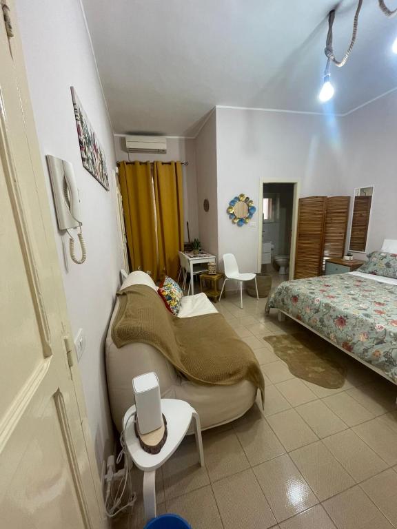 a bedroom with a bed and a table and chairs at residence Gaja in Gaeta