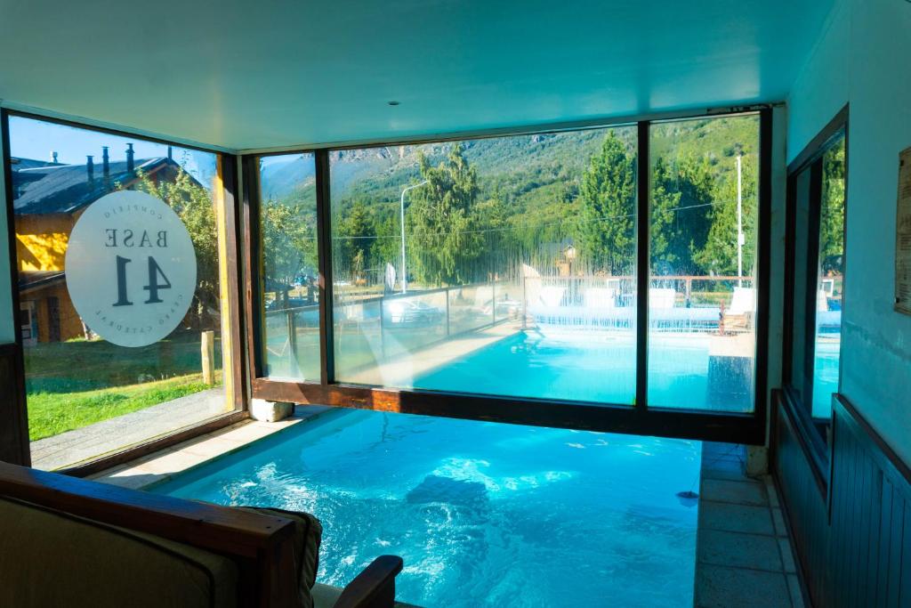 a view of a swimming pool through a window at Las Rocas By Base 41 in San Carlos de Bariloche