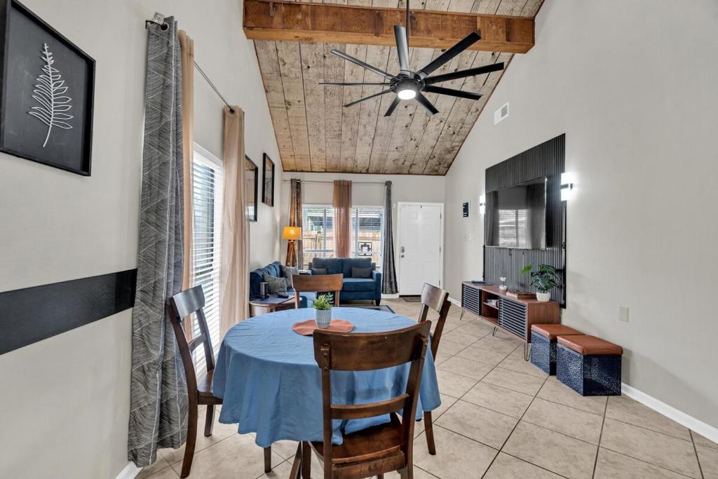 a dining room and living room with a table and chairs at LSU Tiger Den in Baton Rouge