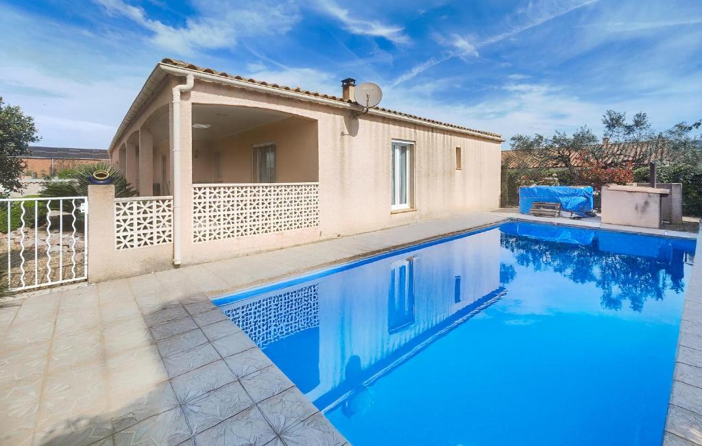 a swimming pool in front of a villa at Nice Home In Cessenon Sur Orb - Flh677 in Cessenon
