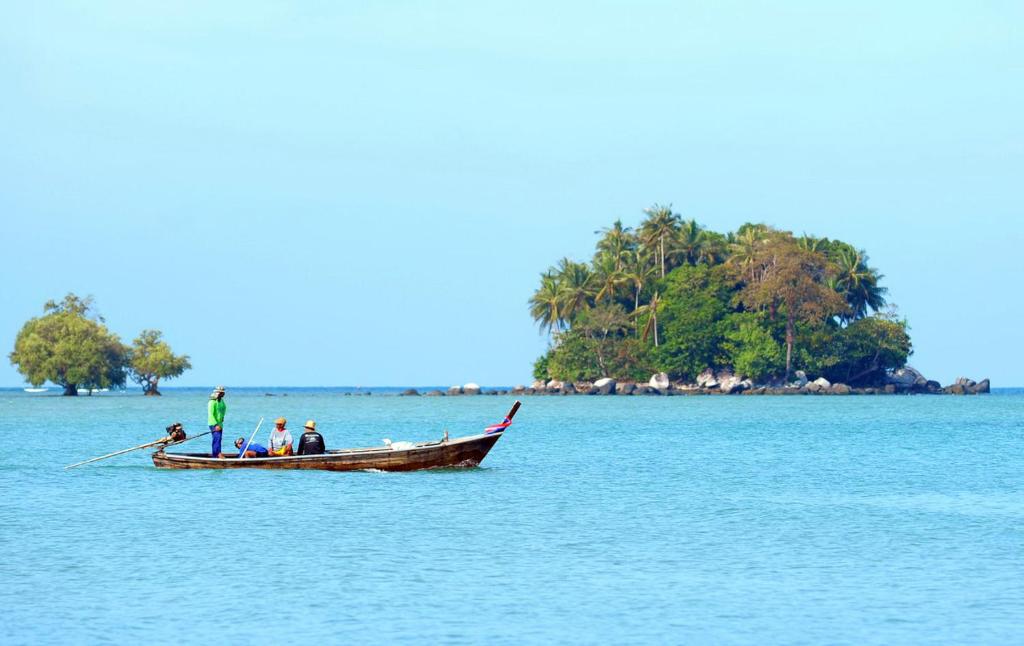 a group of people in a boat in the water at Happy Place Official in Nai Yang Beach