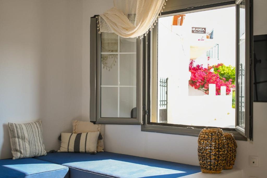 a room with a blue bench and a window at Selanna Luxury Apartments in Skiathos Town