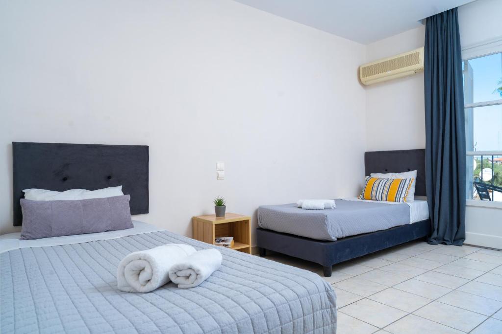 Postel nebo postele na pokoji v ubytování Blue Palm Hotel