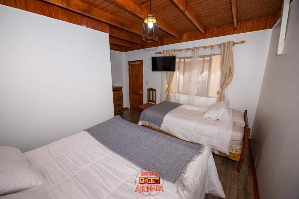 Una cama o camas en una habitación de Hospedaje Ahumada