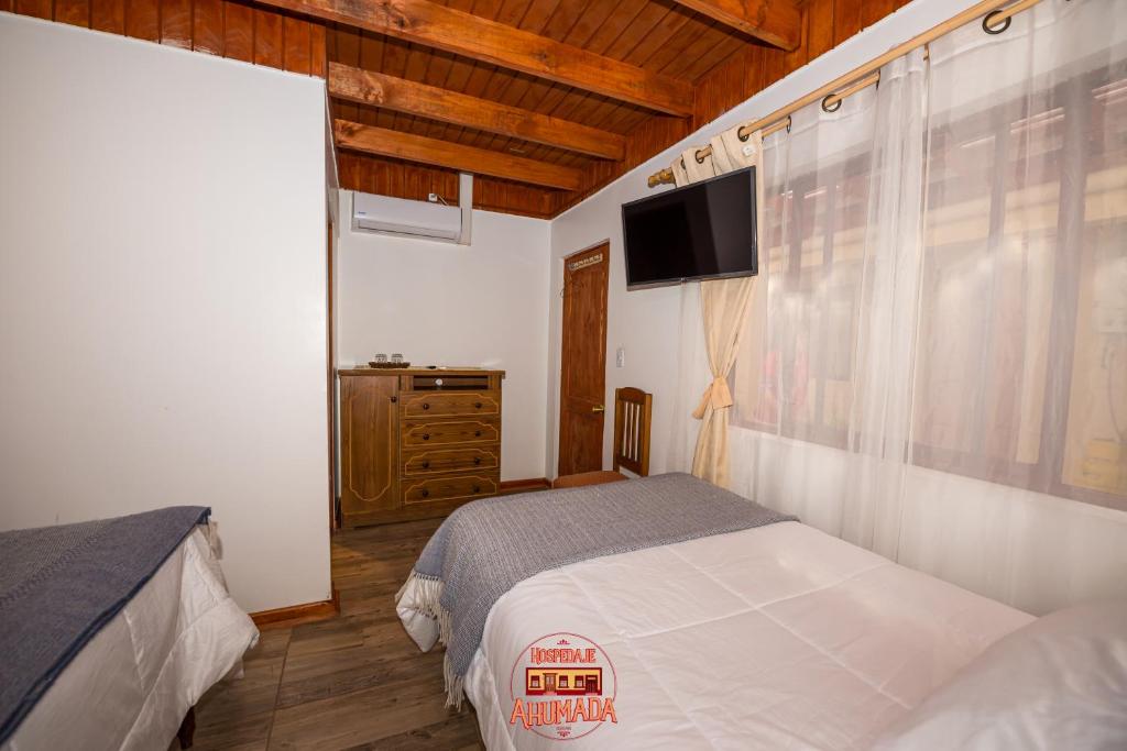 Una cama o camas en una habitación de Hospedaje Ahumada