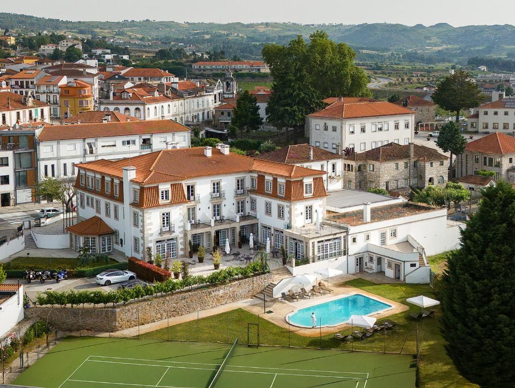 an aerial view of a mansion with a tennis court at Forrester Essence Douro Hotel - by Unlock Hotels in Alijó